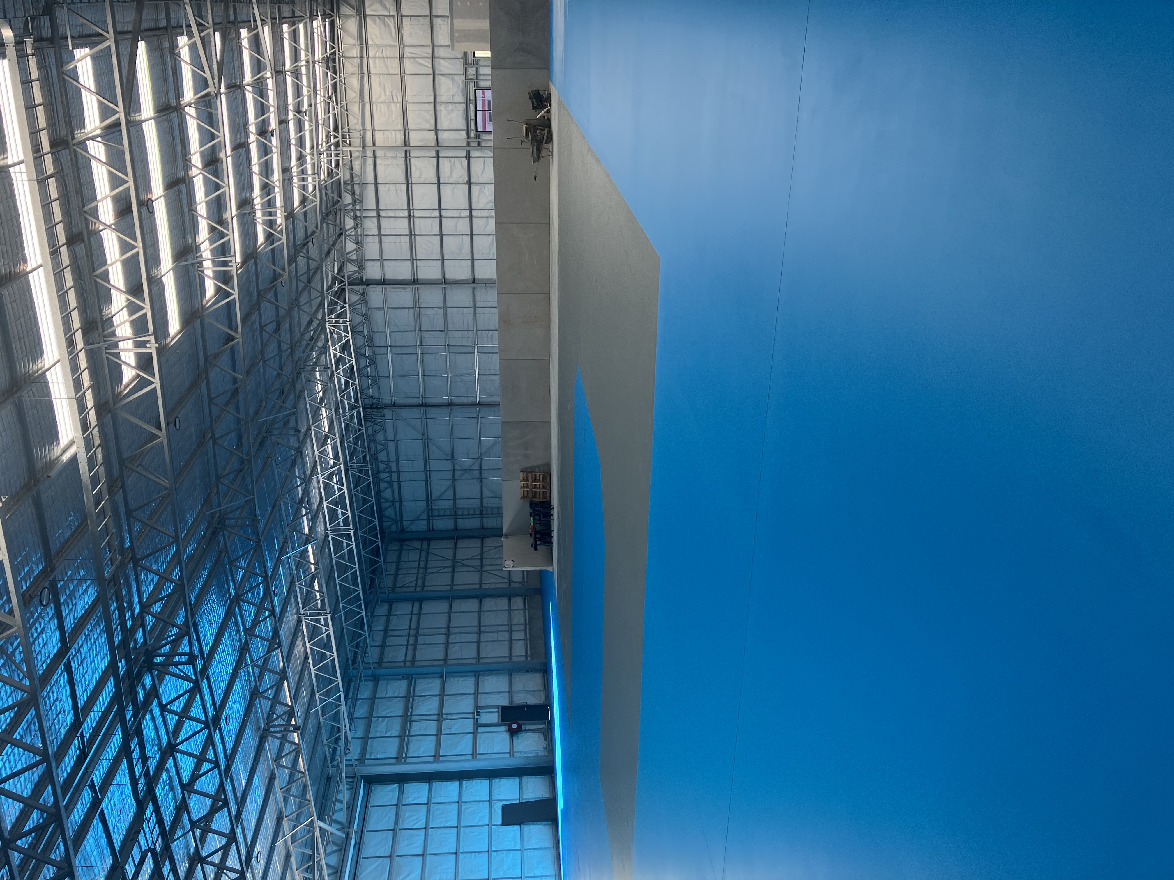 Airworx X+ red industrial dust extractor supporting concrete shot blasting and grinding works on warehouse floor