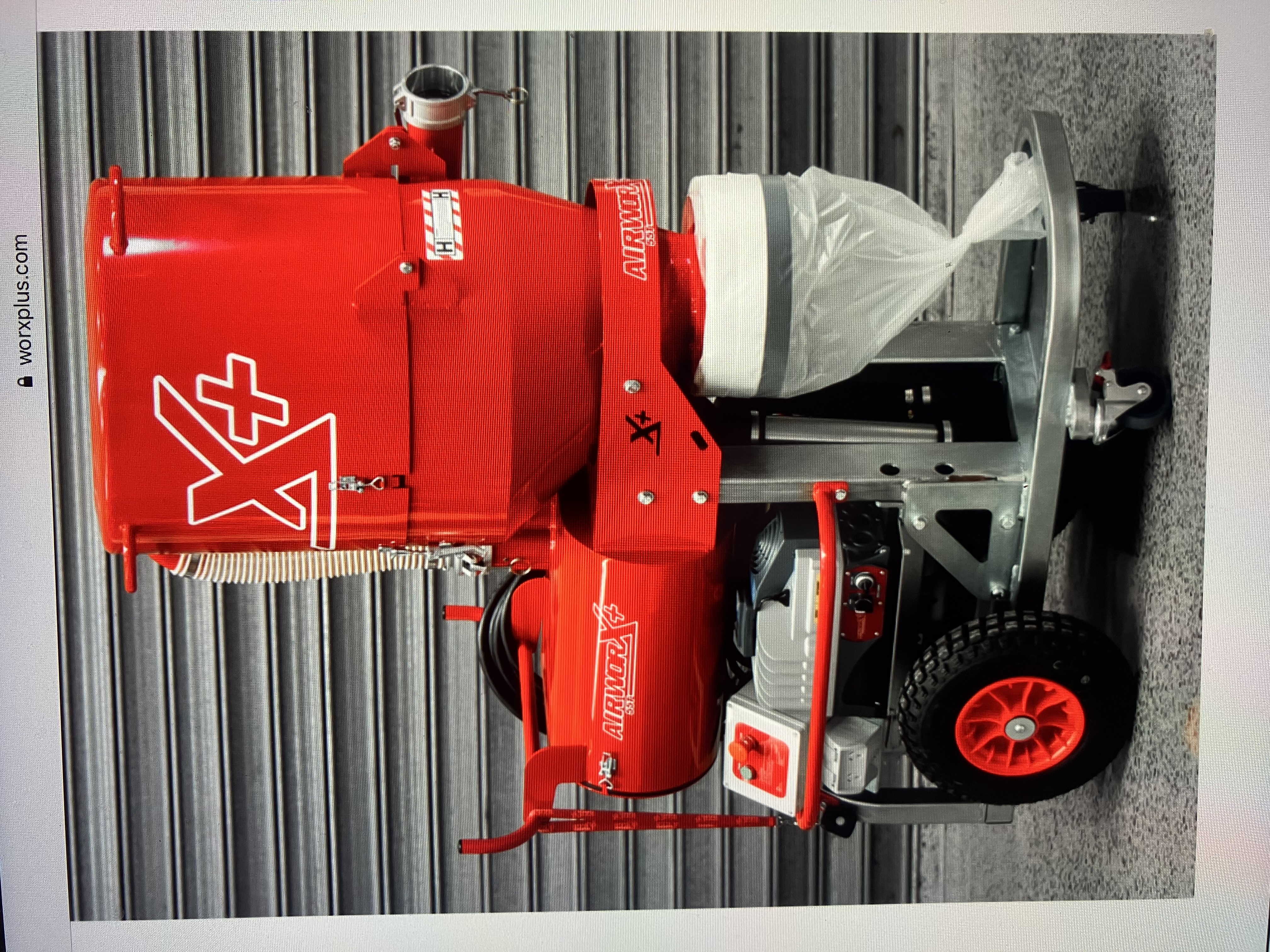 Red industrial dust extraction unit in large warehouse during concrete floor preparation works in Perth
